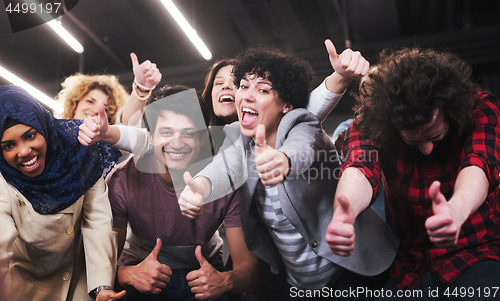 Image of portrait of young excited multiethnics business team