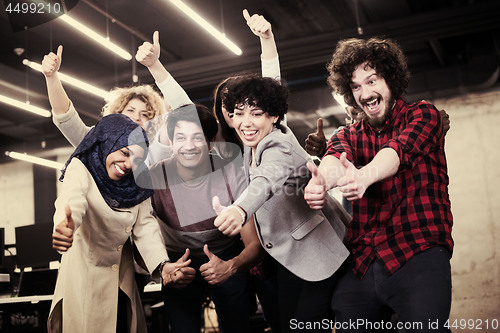 Image of portrait of young excited multiethnics business team