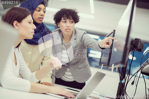 Image of multiethnics team of software developers working together