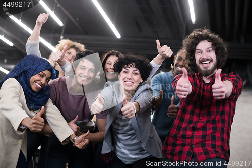 Image of portrait of young excited multiethnics business team