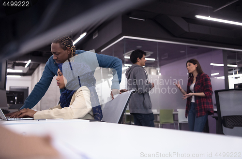 Image of young black muslim female software developer at work