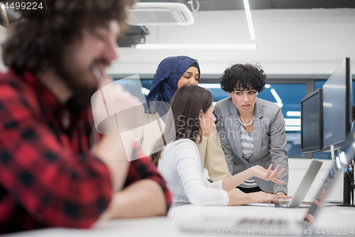 Image of young multiethnics team of software developers working together