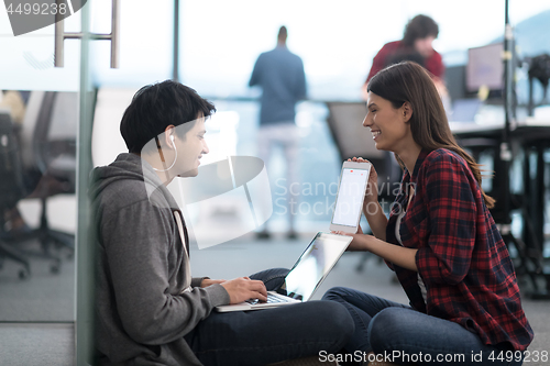 Image of software developers couple working on the floor