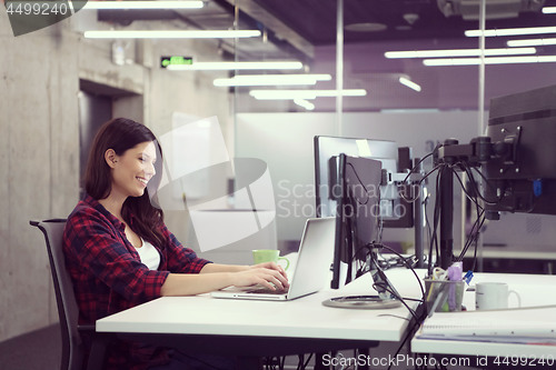 Image of female software developer using laptop computer