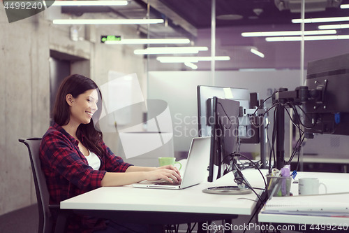 Image of female software developer using laptop computer