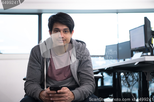 Image of software developer using mobile phone