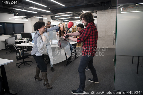 Image of multiethnics business team boxing at office