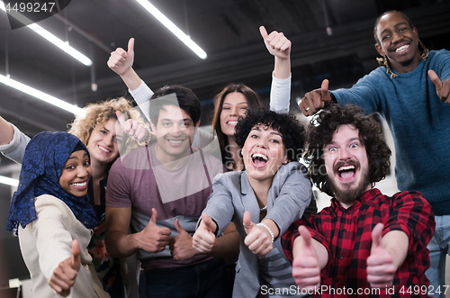 Image of portrait of young excited multiethnics business team