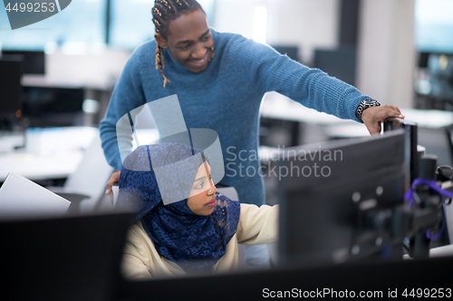 Image of young black muslim female software developer at work