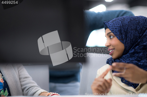 Image of black muslim female software developer at work