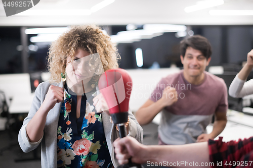 Image of multiethnics business team boxing at office