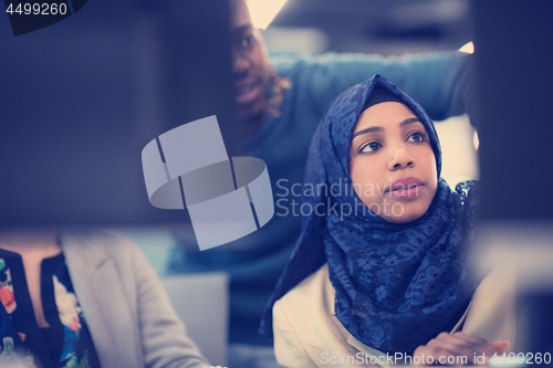 Image of black muslim female software developer at work