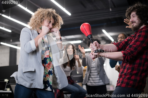 Image of multiethnics business team boxing at office