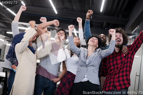 Image of portrait of young excited multiethnics business team