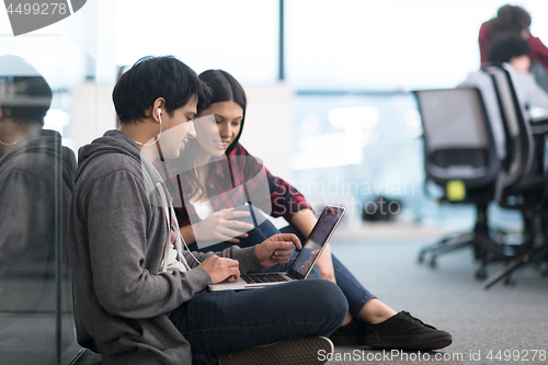 Image of software developers couple working on the floor