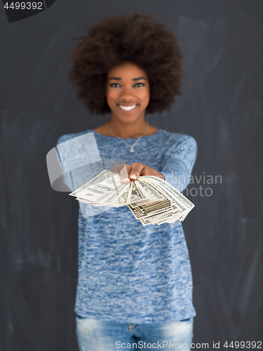 Image of black woman holding money on gray background