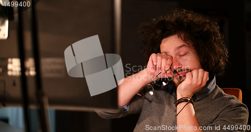 Image of man working on computer in dark office
