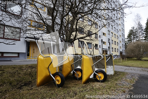 Image of lot of empty new garden wheelbarrows in the yard