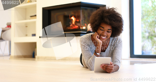 Image of black women using tablet computer on the floor
