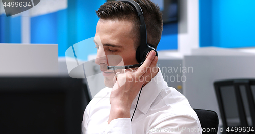 Image of male call centre operator doing his job