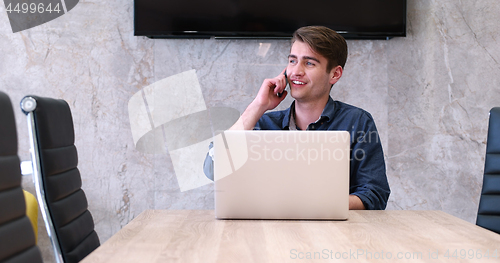 Image of businessman working using a laptop in startup office