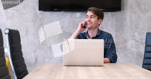 Image of businessman working using a laptop in startup office