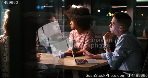 Image of Multiethnic startup business team in night office