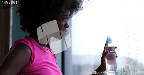 Image of portrait of young afro american woman in gym on workout break