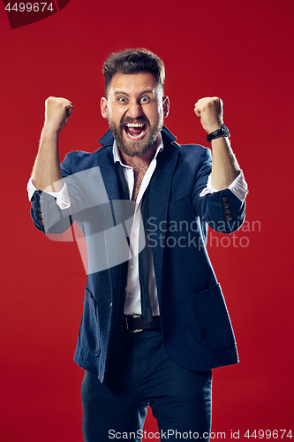 Image of Winning success man happy ecstatic celebrating being a winner. Dynamic energetic image of male model