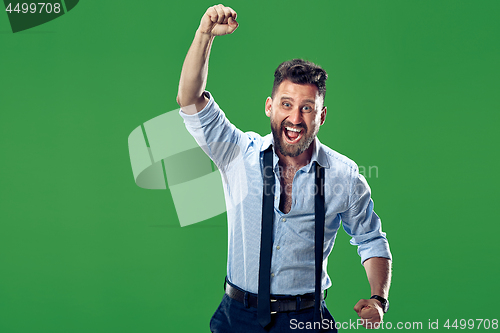 Image of Winning success man happy ecstatic celebrating being a winner. Dynamic energetic image of male model