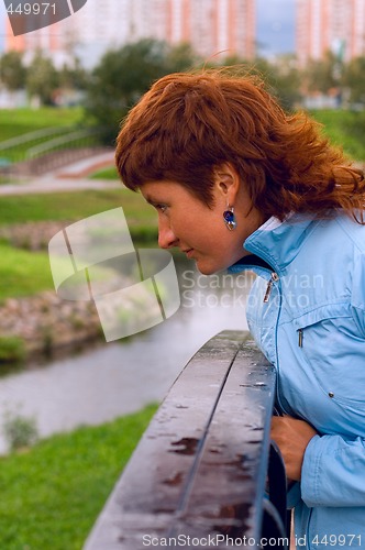 Image of redhead woman on the bridge