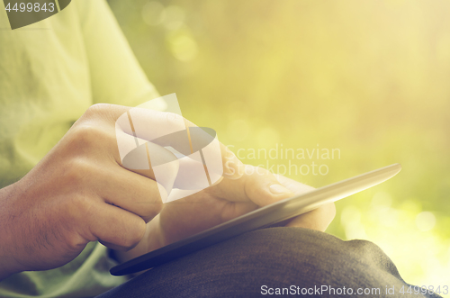 Image of Man holding tablet