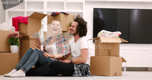 Image of young couple moving  in new house