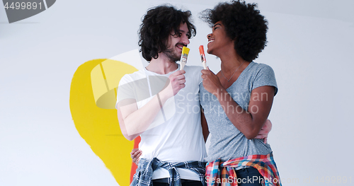 Image of couple with painted heart on wall