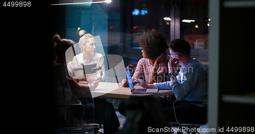 Image of Multiethnic startup business team in night office