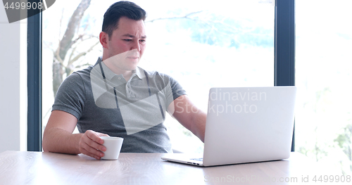 Image of businessman working using a laptop in startup office