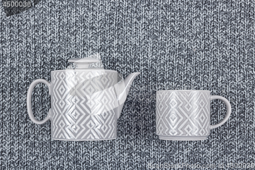 Image of Ceramic teapot and cup on gray wool background