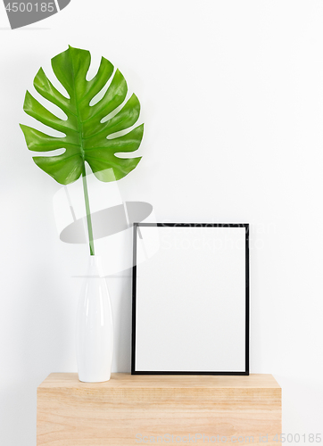 Image of Tropical leaf in a white vase and black picture frame