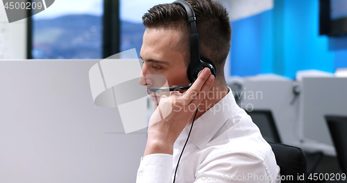 Image of male call centre operator doing his job