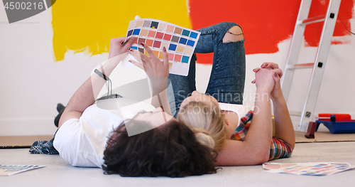 Image of Happy young couple relaxing after painting