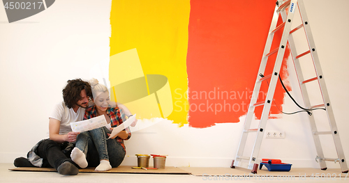 Image of Happy young couple relaxing after painting