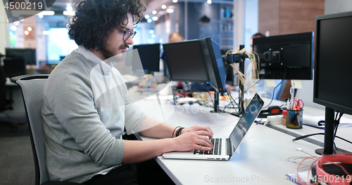Image of businessman working using a laptop in startup office