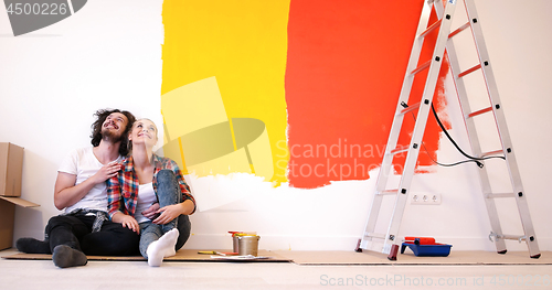 Image of Happy young couple relaxing after painting