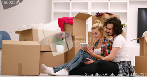 Image of young couple moving  in new house