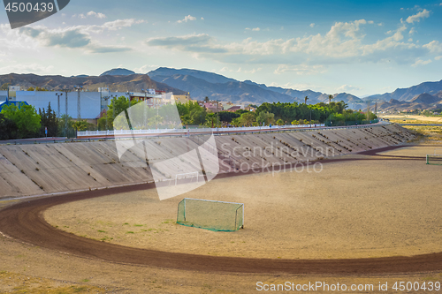 Image of A football field on the mountain s on tha background.