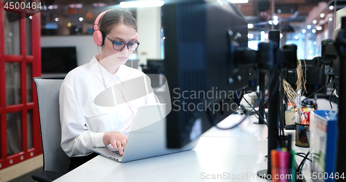 Image of businesswoman using a laptop in startup office