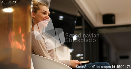 Image of beautiful woman at home reading book