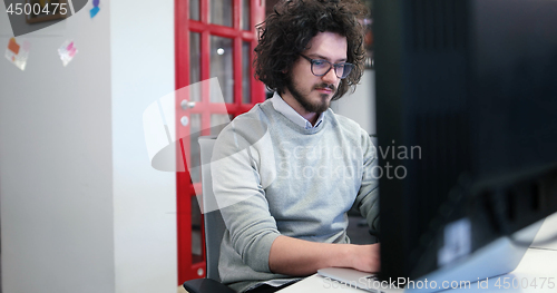 Image of businessman working using a laptop in startup office