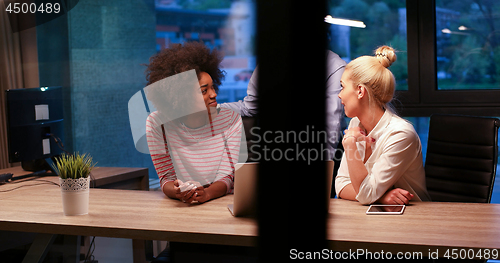 Image of Multiethnic startup business team in night office