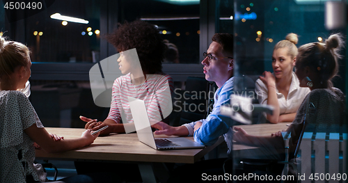 Image of Multiethnic startup business team in night office